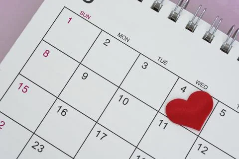Red heart shape on the date of the 4th day in the calendar. Stock Photos
