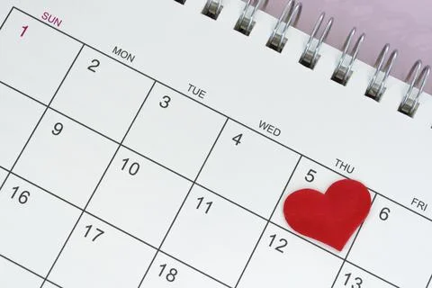 Red heart shape on the date of the 5th day in the calendar. Stock Photos