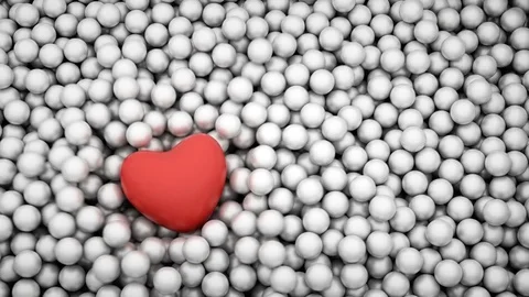 Red heart shape falling into glossy balls Stock Footage 83518724