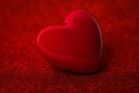 The red Heart shape on red abstract light glitter background in Stock Photos