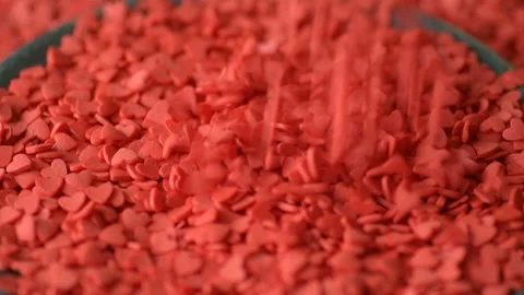 Red heart shaped confetti fall cover green plate Stock Footage 146750898