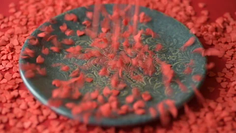 Red heart shaped confetti fall on green plate Stock Footage 146752519