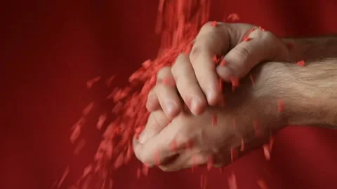 Red heart shaped confetti fall in man's hands Stock Footage 147033418