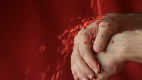 Red heart shaped confetti fall in man's hands Stock Footage 147033675