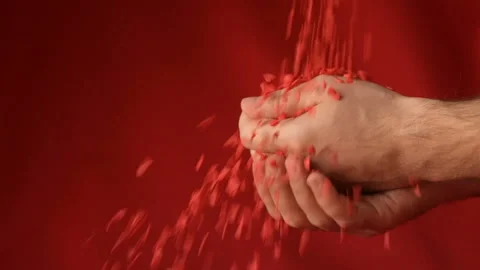 Red heart shaped confetti fall in man's hands Stock Footage 147033746