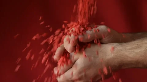 Red heart shaped confetti fall in man's hands Stock Footage 147033753