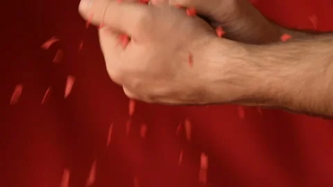 Red heart shaped confetti fall in man's hands Stock Footage 147034409