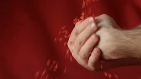 Red heart shaped confetti fall in man's hands Stock Footage 147034517