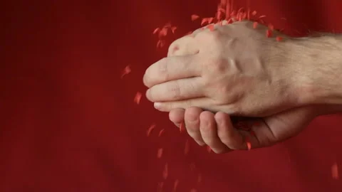 Red heart shaped confetti fall in man's hands Stock Footage 147034743