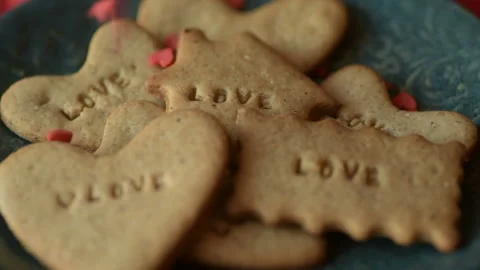 Red heart shaped confetti fall on love cookie Stock Footage 147037222