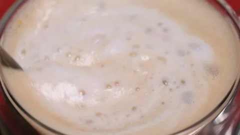 Red heart shaped confetti fall in cappuccino foam Stock Footage 147367484