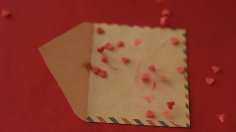 Red heart shaped confetti fall in valentine card Stock Footage 147367806