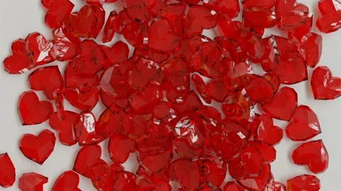 Red heart-shaped crystals falling and piling on white background for Valentine's Stock Footage 169644513