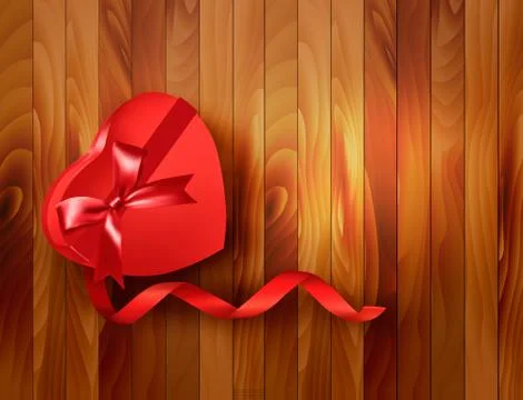 Red heart-shaped gift box with ribbon on wooden background. vector. Stock Illustration