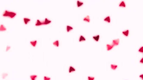 Red heart-shaped sequins are spinning in a circle on a pink background Stock Footage 168934106