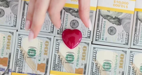 Red heart on stack of hundred dollar bills Stock Footage 285482395