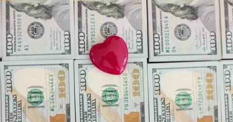 Red heart on a stack of hundred dollar bills Stock Footage 287551912