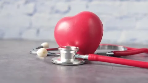 Red heart with stethoscope on table, concept of health care, heart checkup,.. Stock Footage 333151957