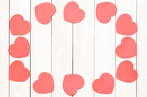 Red heart stickers on a light wooden background Foto stock