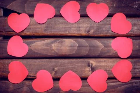 Red heart stickers on a wooden background Foto stock