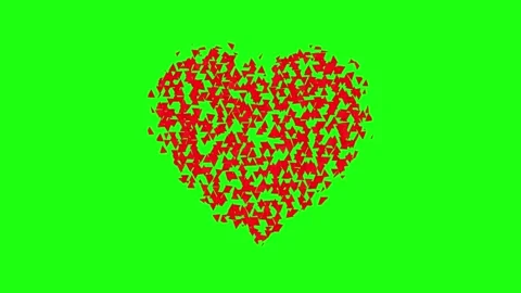 Red heart symbol exploding into small particles against vibrant green scree.. Vídeos de archivo 343551516