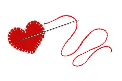 Red heart, thread and needle isolated on white 库存照片