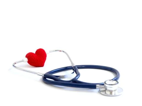 Red heart using stethoscope on the white background (Isolated background).  C Foto stock