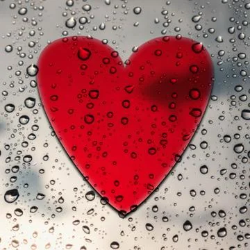 Red heart on a window with rain drops Illustrazione stock