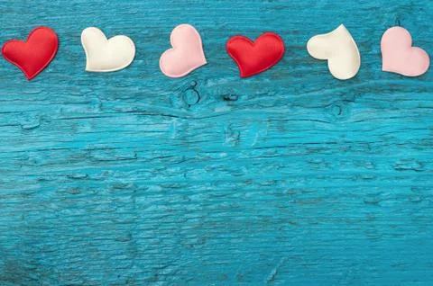 Red hearts on the blue boards Stock Photos