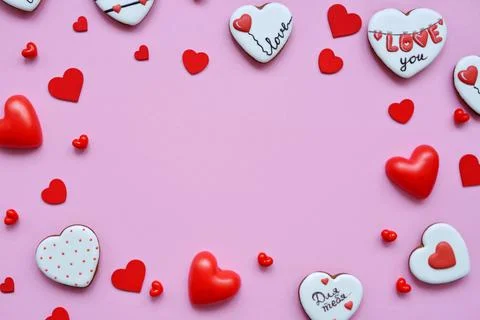 Red hearts of different shapes on a solid background. gift wrapped in craft p 스톡 사진