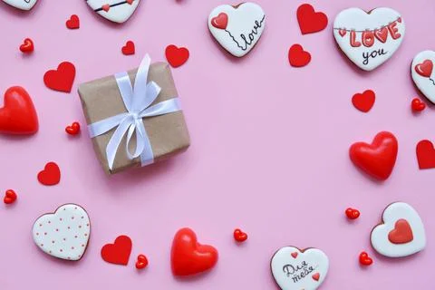 Red hearts of different shapes on a solid background. gift wrapped in craft p 스톡 사진