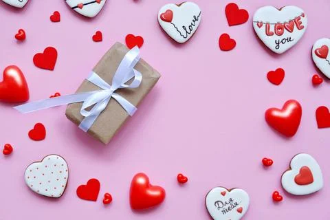 Red hearts of different shapes on a solid background. gift wrapped in craft p 스톡 사진