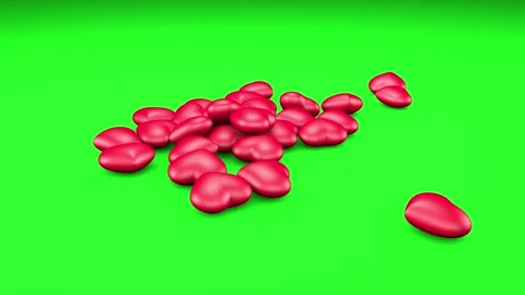 Red hearts fall on a green background. Stock Footage 253877948