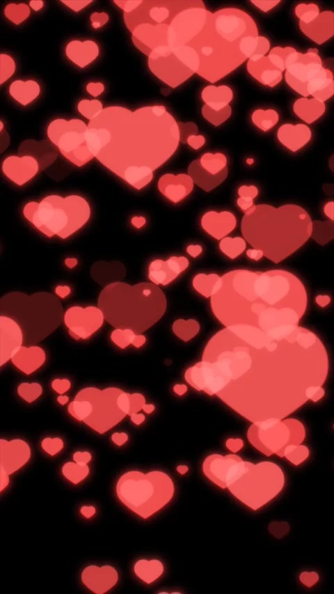 Red hearts gently drift against a black background Stock Footage 313123635