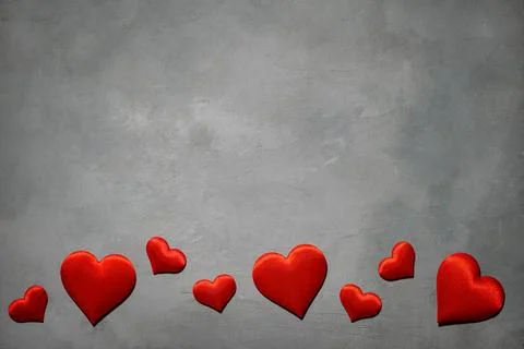 Red hearts on a gray background. Background for a postcard Stock Photos