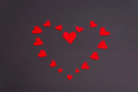 Red hearts lined on a dark background Stock Photos
