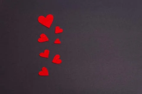 Red hearts lined on a dark background Stock Photos