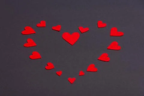 Red hearts lined on a dark background Stock Photos