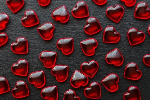 Red hearts pattern on black background, flat lay Stock Photos