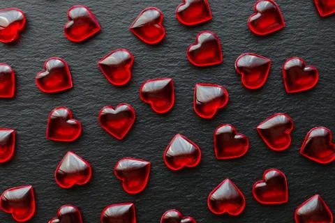 Red hearts pattern on black background, flat lay Stock Photos