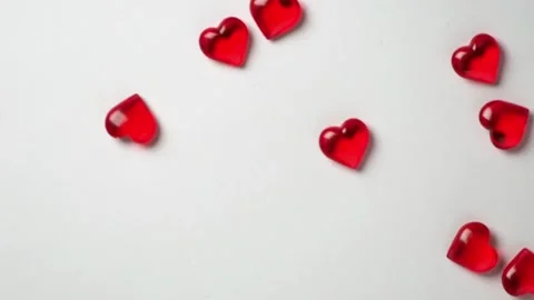 Red hearts pour into white background Stock Footage 147331179