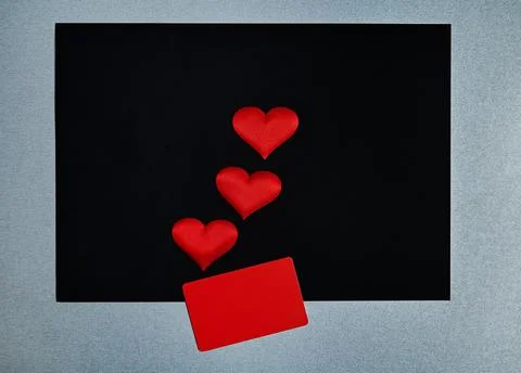 Red hearts, red rectangle on a black / gray background. Border, copy space, t Stock Photos