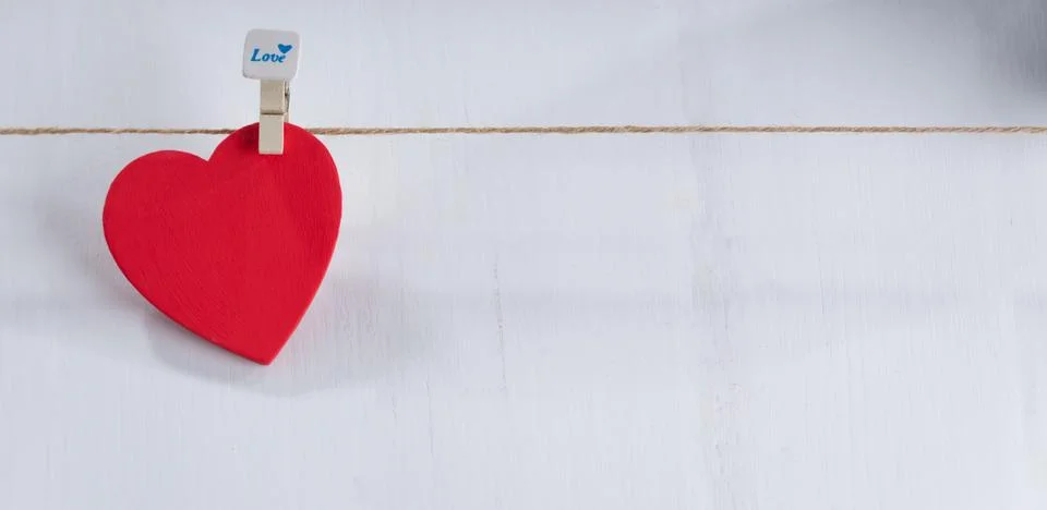 Red hearts set on string over white background. Stock Photos