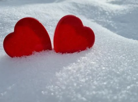Red hearts in the snow Stock Photos