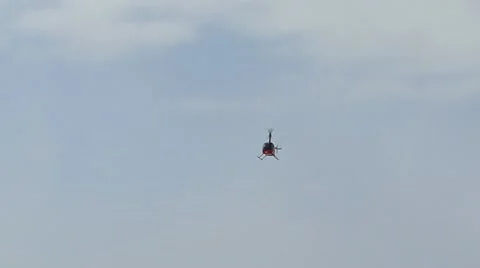 Red Helicopter Descending Approach through Snow Stock Footage 10841015