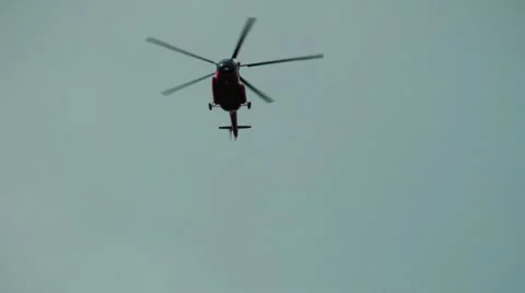 The red helicopter flies very quickly and low over the earth Stock-Footage 12314887