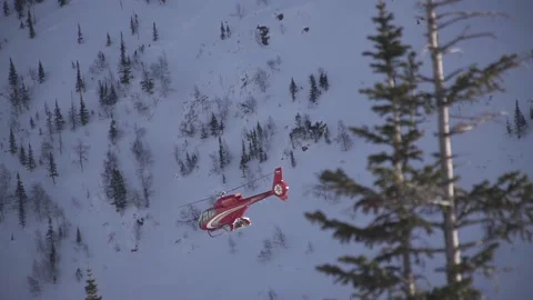Red helicopter flying in the mountains Stock Footage 94406924