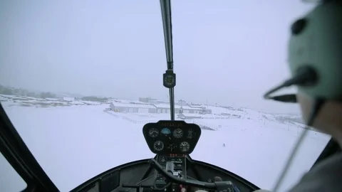 A red helicopter is flying over the snowy city. Stock Footage 80319141