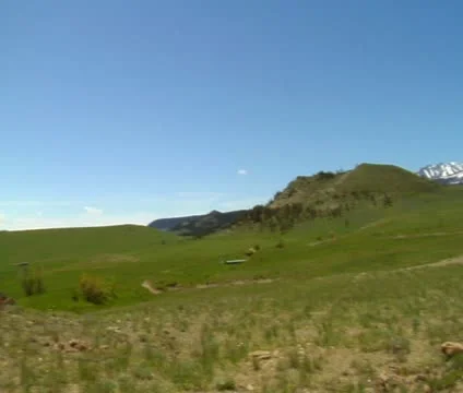 Red helicopter preparing for take-off in grassy field Stock Footage 21602316