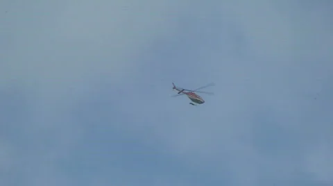 Red helicopter in sky Stock Footage 809698